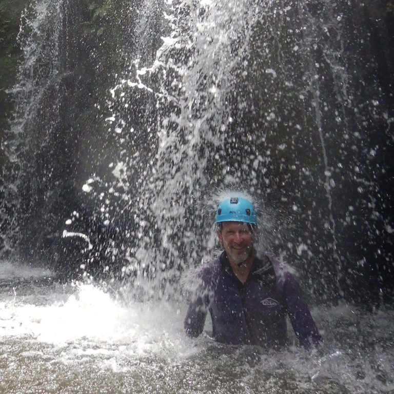 Under a waterfall after rappelling down