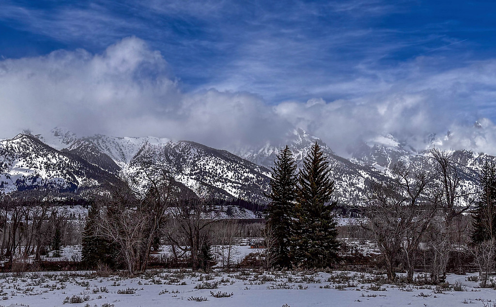 Scenic view of Gran Tetons with clouds covering the peaks