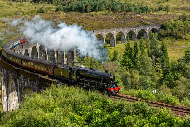 Steam Engine Train Crossing The Glenfinnan Viaduct